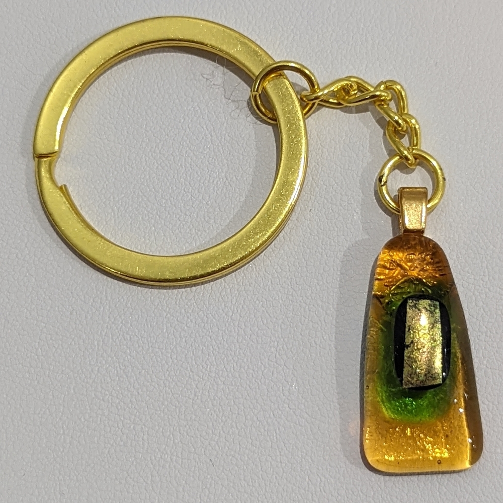 Artisan Handmade glass bag charm keychain with orange metallic design